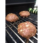 Ground chuck on the grill with onions and seasoning